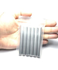 Hand holding 6 pack 3 eighth inch dowel pins 3 inch long shelf pins alloy steel for wood furniture and bunk beds