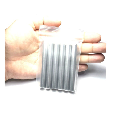 Hand holding 6 pack 3 eighth inch dowel pins 3 inch long shelf pins alloy steel for wood furniture and bunk beds