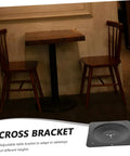 Built Tough Cast Iron Table Leg Brackets With Five Hole Mounting Plates For Rock Solid Furniture Connectors and Heavy Duty Leg Fixators That Keep Your Setup Steady, showcasing black cross bracket under wooden table.