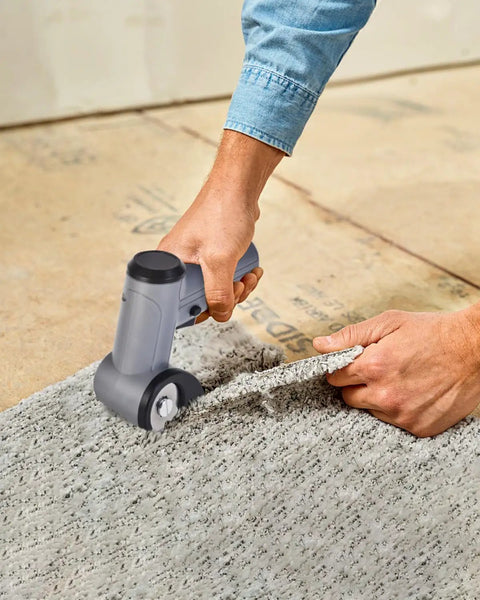 User operating Selumie 2026 New Cordless Electric Scissors, 4V Rechargeable Cardboard Cutter on grey carpet.