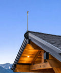 Heavy Duty Adjustable Roof Sprinkler System for Wildfire Protection prewets eaves gutters, shown on a wooden roof peak.