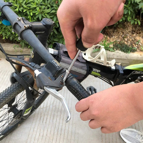 Person using Pink 39 Piece All Purpose Household Tool Kit Set for Women for bike repair with screwdriver.