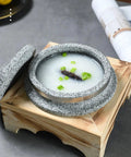 Dolsot Style Granite Stone Bowl With Lid 14 Cm on wooden holder filled with rice porridge and garnished, ideal for hot dishes