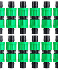 Front view of 12 green plastic 5/8 inch drip irrigation couplings with black rubber O-rings
