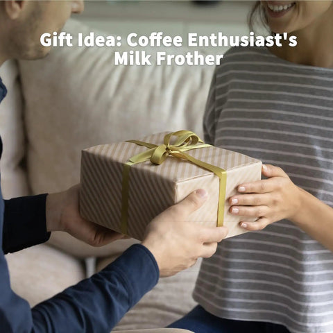 Person giving a wrapped gift box labeled 'Coffee Enthusiast's Milk Frother', for Barista Grade Milk Frother With Variable Temperature And Froth Thickness For Lattes And Hot Chocolate 21 Oz Capacity With Smart Touch Control Dishwasher Safe And Memory Function