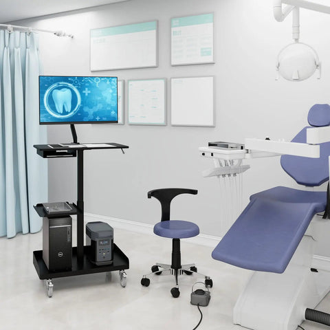 Heavy Lifter Mobile Workstation Cart With No Sweat Rolling Casters And Fully Adjustable Gas Spring Monitor Stand Plus Secure CPU Tray For Seamless Standing Desk Transitions In Matte Black in a dental office setting.