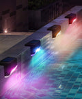 Solar Pool Side Lights 4 Pack Color Changing Waterproof LED Deck Lights illuminating poolside with vibrant colors