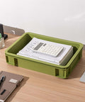 Heavy Duty Stackable Plastic Storage Bin For Kitchen, Bathroom, Office And Camping, Multi Purpose Organizer Tote, Undersink Cabinet Storage, Built To Last With Reinforced Edges, Green 2L And 2S on office desk with papers.