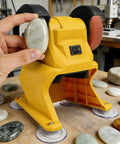 Depisuta Mini Bench Grinder 5500Rpm For 18-21V Li Ion Battery dual wheels with sanding disc in use on countertop.