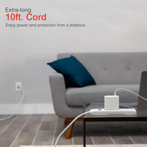 No Fuss Rock Solid Surge Protector Power Strip With Ten Foot Extension Cord on a coffee table next to a laptop.