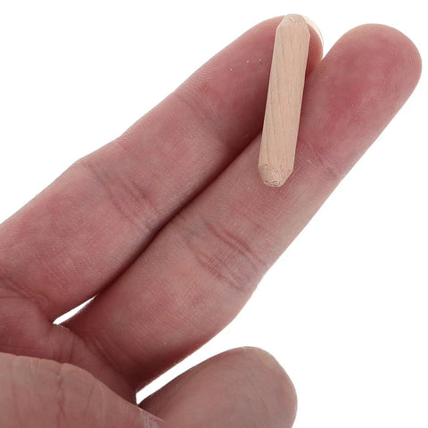 Close-up of hand holding 100 Piece Wood Dowels 6x30mm Fluted Dowel Pins With Beveled Ends Sanded Smooth and Splinter Free