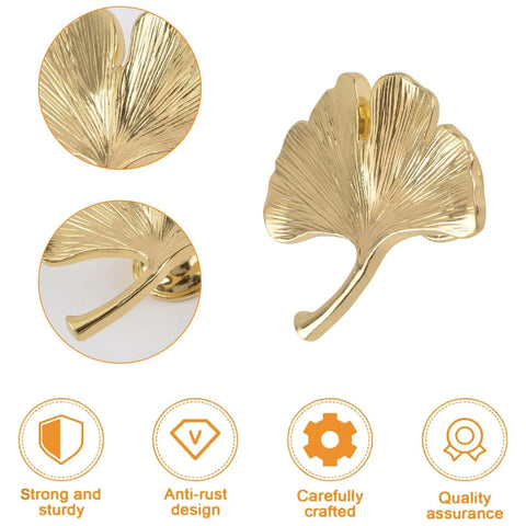 Close-up of Six Piece Ginkgo Leaf Cabinet Knobs And Solid Zinc Drawer Pulls In Rustproof Brushed Gold Finish, showing leaf design.