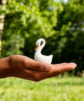 2 Pack Ceramic Swan Toilet Bowl Bolt Caps And Decorative Bird Screw Covers Bathroom Furniture Hardware Easy Peasy Install shown in hand outdoors.
