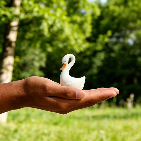 2 Pack Ceramic Swan Toilet Bowl Bolt Caps And Decorative Bird Screw Covers Bathroom Furniture Hardware Easy Peasy Install shown in hand outdoors.