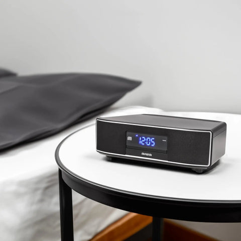 Exos Home Speaker With 30W RMS Power, Bluetooth Streaming, CD player on bedside table in modern bedroom