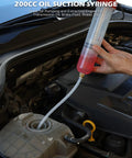 200Cc No Sweat Fluid Extractor Pump With Hella Long Flexible Silicone Hose And Twin Extension Tubes in use for fluid extraction.