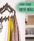 Knockout Five Hook Cast Iron Wall Hanger In Rustic Brown Fleur De Lis Farmhouse Entryway Coat Rack holds scarves and keys.
