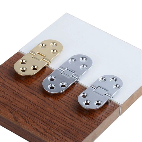 Flush Mounted Folding Hinges For Self-Supporting Door Flaps, DIY-Friendly Install, gold and silver hardware display on wood surface