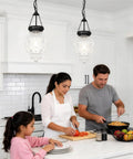 Black Kitchen Island Pendant Light With Adjustable Height From 22 To 56 Inches, glass shade in modern kitchen setting.