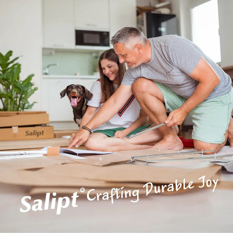 Couple assembling furniture with dog in room full of Salipt packaging, enjoying DIY process at home.