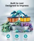 Colorful dragon models in front of spools of Silk PLA Plus Filament 1.75mm 1kg Silver With Chrome Like Gloss Finish And Smooth Silk Texture.