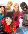 Group smiling in snow; one wearing Three Hole Knit Ski Mask Balaclava for Winter Warmth, full face cover with heart design, outdoor.
