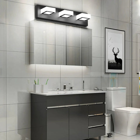 Three Light Black Vanity Lighting Fixture With Acrylic Shades, modern LED bathroom wall light above mirror on black metal frame.