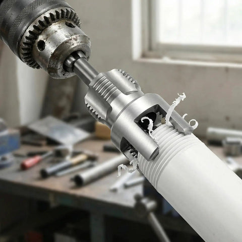 Top Rated 6 Piece Pipe Threading Tool Kit For Pvc cutting PVC pipe with high carbon steel cutter attached to electric drill.