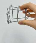 Pair Of Badass Fire Sprinkler Head Guards Made From Rust Resistant Stainless Steel Heavy Duty Cage Covers For One Half And Three Quarter Inch Systems shown in hand.