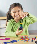 Child playing with 122 Piece Magnetic Science Kit For Kids With Colorful Chips, Magnetic Balls, Wands, Magnets, And Rings