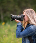 Photographer using Nikkor Z 24-120mm F4 S Do It All Zoom Lens For Z Series Mirrorless Cameras in a natural setting, close focus ability.