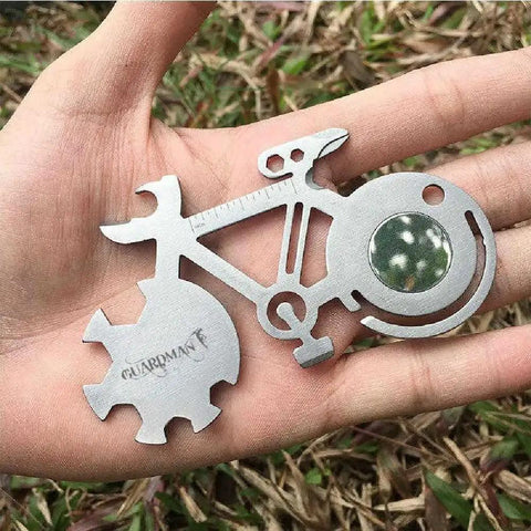All In One Bicycle 10 In 1 Multitool Card For Everyday Carry And Keychain Access with wrenches, in a hand, outdoor background