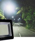 Led Flood Light on a dark road, showcasing bright illumination for outdoor security, made with durable materials, IP66.