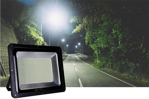 Led Flood Light on a dark road, showcasing bright illumination for outdoor security, made with durable materials, IP66.
