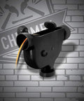 Portable Cord Winder Organizer with black swiveling bracket for quick cable wrangling against a brick wall background
