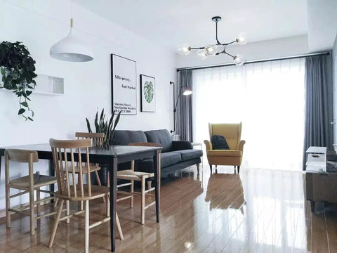 Living room featuring a 60 Watt Modern Elegance White Pendant Light Fixture with industrial metal shade and minimalist design.