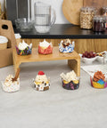 Assorted cupcakes in colorful Greaseproof Cupcake Liners 4000 Pack, 4 Oz Disposable Muffin Cups For Oven Or Freezer on display