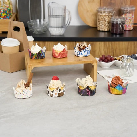 Assorted cupcakes in colorful Greaseproof Cupcake Liners 4000 Pack, 4 Oz Disposable Muffin Cups For Oven Or Freezer on display