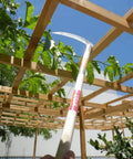 Heavy Duty Pick Mattock For Tough Soil With Extra Thick Forged Steel, Ergonomic Hand Tool, shown under garden pergola