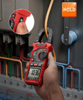 Digital Clamp Meter Multimeter With Auto-Ranging 4000 Counts For AC And DC Voltage And Current, Resistance, Capacitance, Frequency, Duty Cycle, Diode, Continuity, Live Wire NCV Test, Non Contact Voltage Detection, Pro Grade Tool For Pros And DIY red clamp meter on electrical panel with hold button