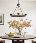 Elwood 25-Inch 5-Light Industrial Rustic Wagon Wheel Chandelier With Clear Glass Globe Shades And Smoked Birch Finish in dining area.