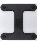 Bottom view of Harvest Inspired Digital Bathroom Scale With Tempered Glass Platform, four non-slip feet, battery compartment visible