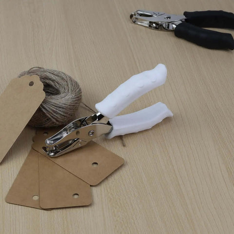One Quarter Inch Circle Hole Puncher with soft grip handle on a table with tags and twine, ideal for crafting projects.