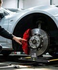 Heavy Duty Tire Alignment Tool Upgraded Automotive Alignment Kit positioned under the wheel for precise adjustments in garage.