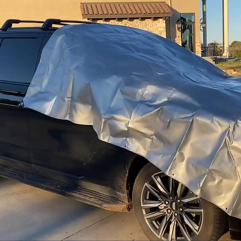 Heavy Duty Waterproof Tarp 10x12 Feet Ten Mil Poly Shelter For Roof And Outdoor Use covering a car, showing grommets and silver finish