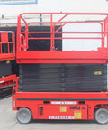 Heavy Duty Electric Hydraulic Lift Platform For Warehouse Vertical Cargo Transfer And Seamless Operation Engineered For Logistics Facilities With Rock Solid High Reach Equipment Handling Built Tough For Daily Grind in red color with adjustable height.