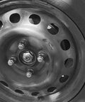 Close-up of a wheel with a pair of M26x15 Front CV Shaft Axle Nuts made from heat treated steel for Honda Accord and Acura.