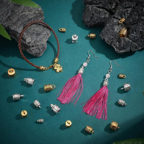 Check Out These 125 Pcs Tibetan Alloy Cord End Caps In 10 Cool Styles With Antique Silver And Golden Tones Perfect For Your Next DIY Jewelry Kit To Fix Necklace Bracelet Tips. Tibetan alloy cord end caps, silver and gold, with tassel earrings and bracelet on teal background.