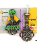 Vintage Pendant Pull Handles Set Of 4 In Distressed Antique Brass, zinc alloy pulls with entangled leaves, shown against credit card.
