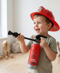 Realistic Water Squirt Fire Extinguisher Toy For Kids Pretend Play Durable Plastic Summer Poolside Splash, child in firefighter hat holding toy.